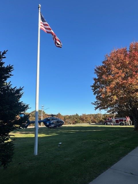 side view of Medflight Helicopter at TFD with flag in foreground